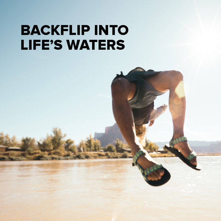 A person wearing Teva Universal waterproof sandals jumping into water