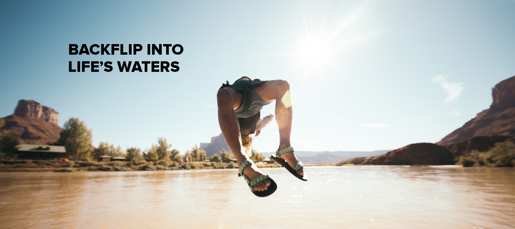 A person wearing Teva Universal waterproof sandals jumping into water